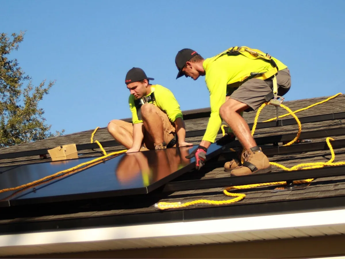 Two Prime Volt installers fitting panels on a roof together